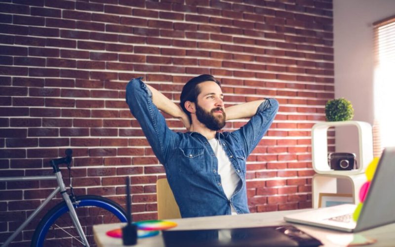 thoughtful-businessman-with-hands-behind-back-relaxing-in-creative-office-1-1024x649